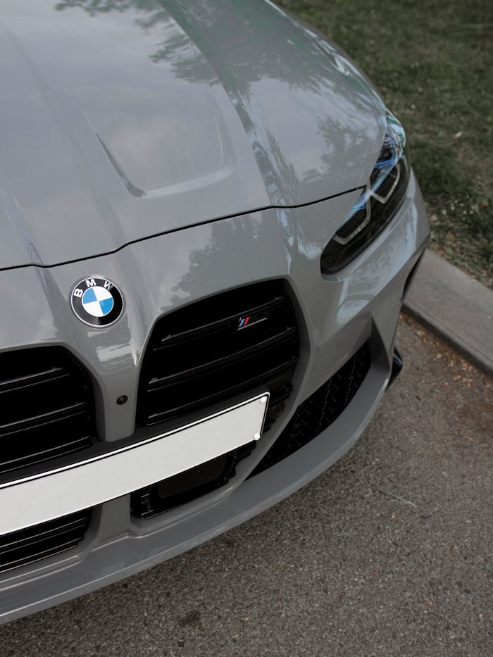 digital-01 Detailed view of the gray front bumper of a BMW M series sports car parked outdoors.